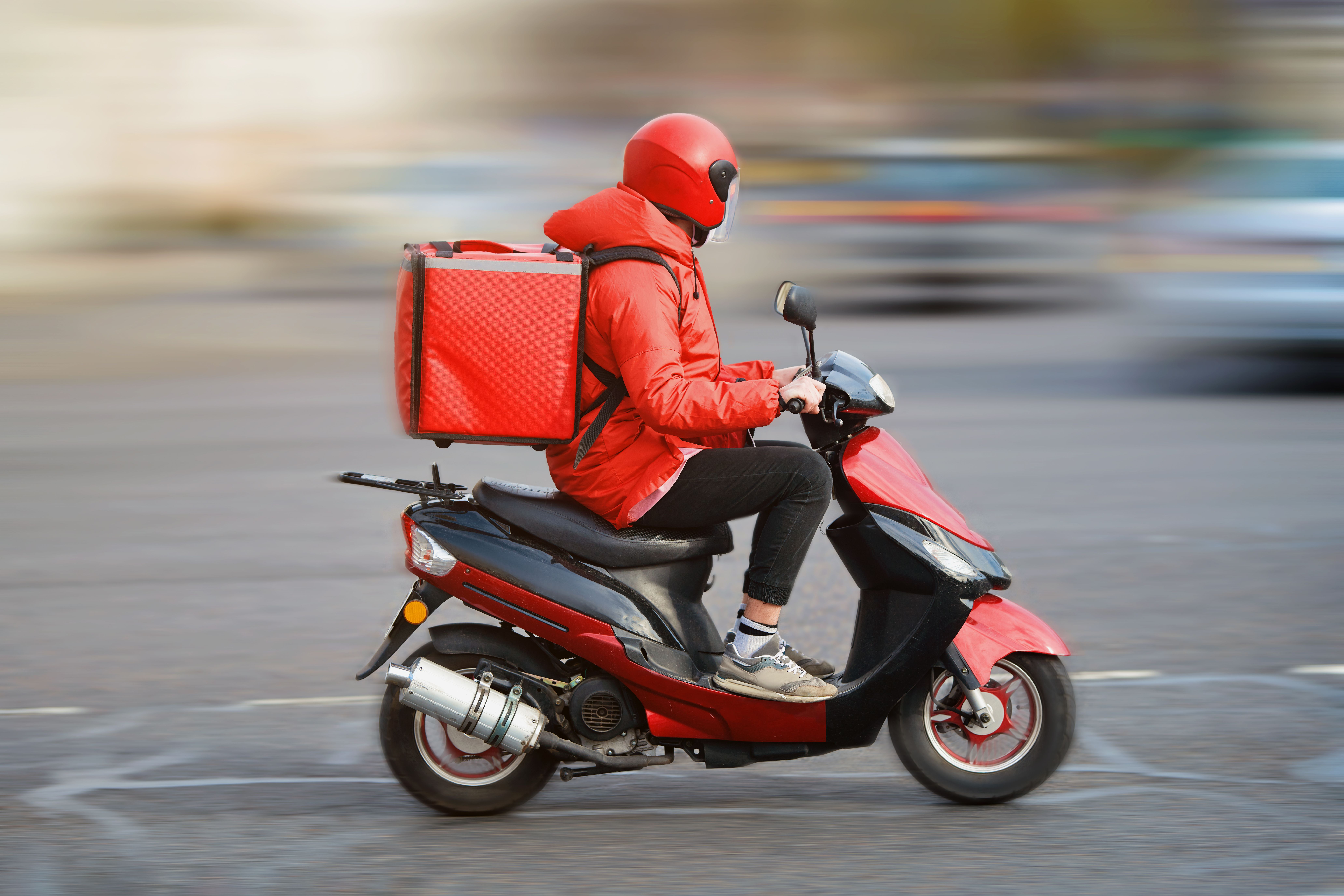 Delivery man on a red moped
