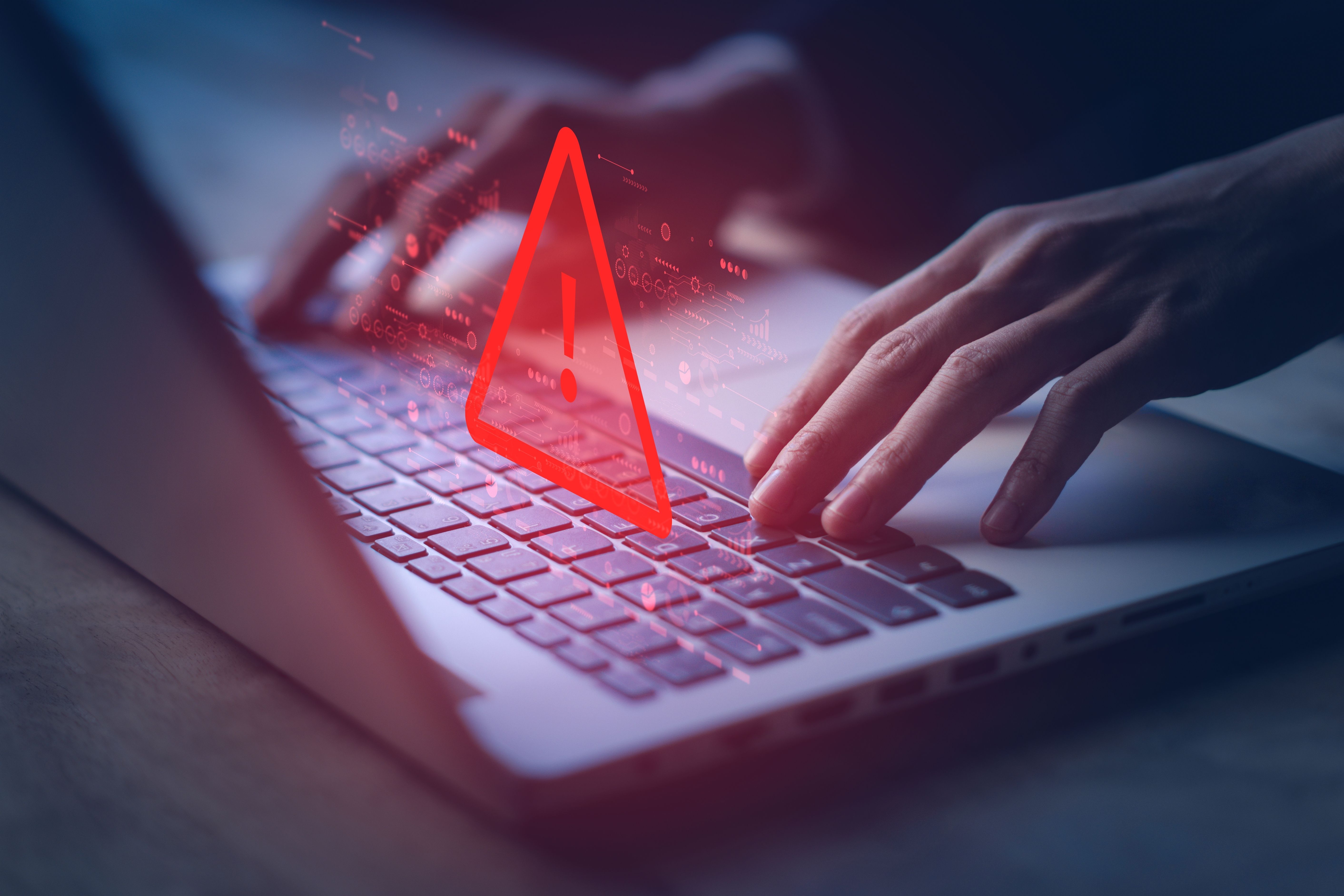 Person on laptop with a warning sign pop-up