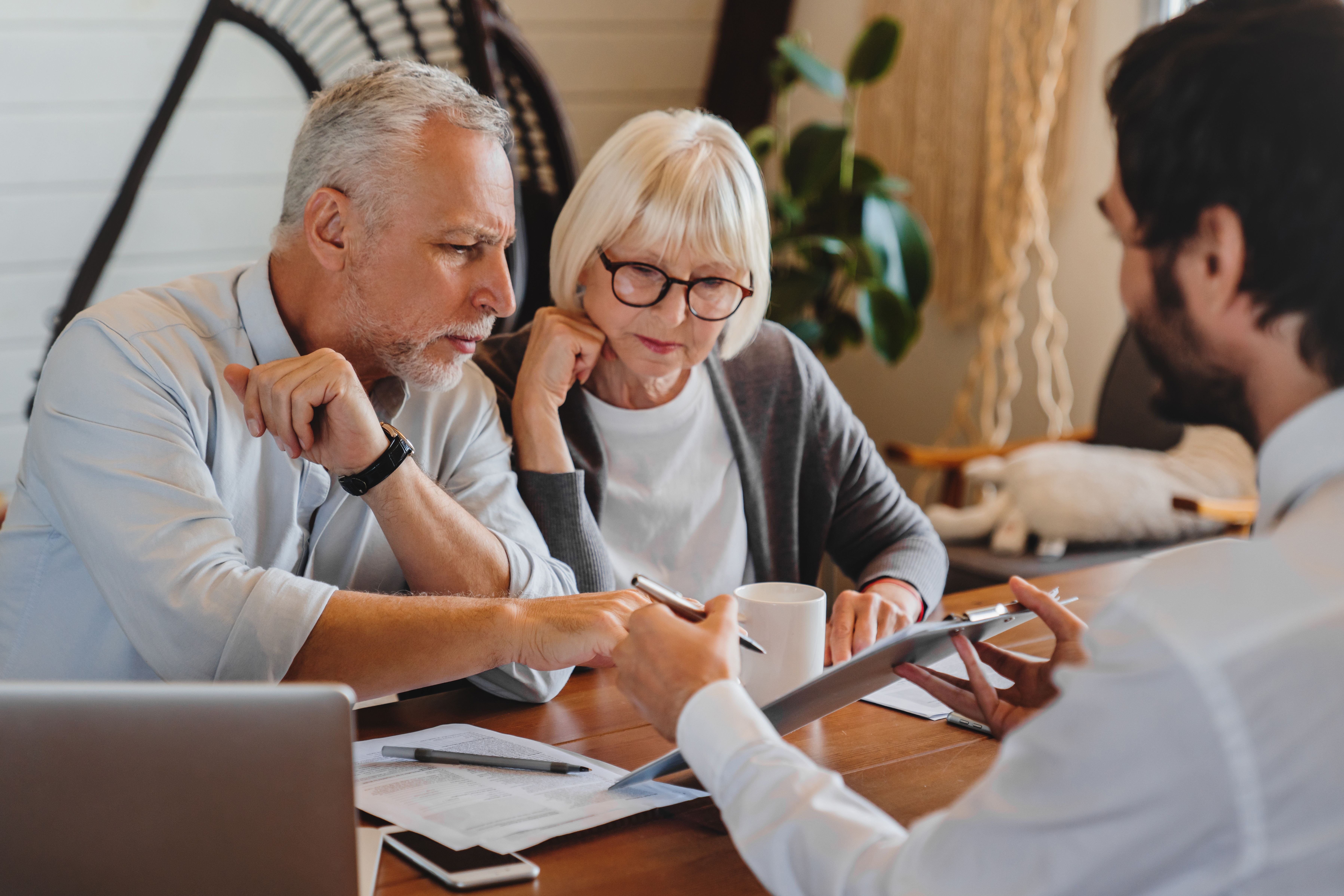 Middle aged couple speaking with a banking advisor