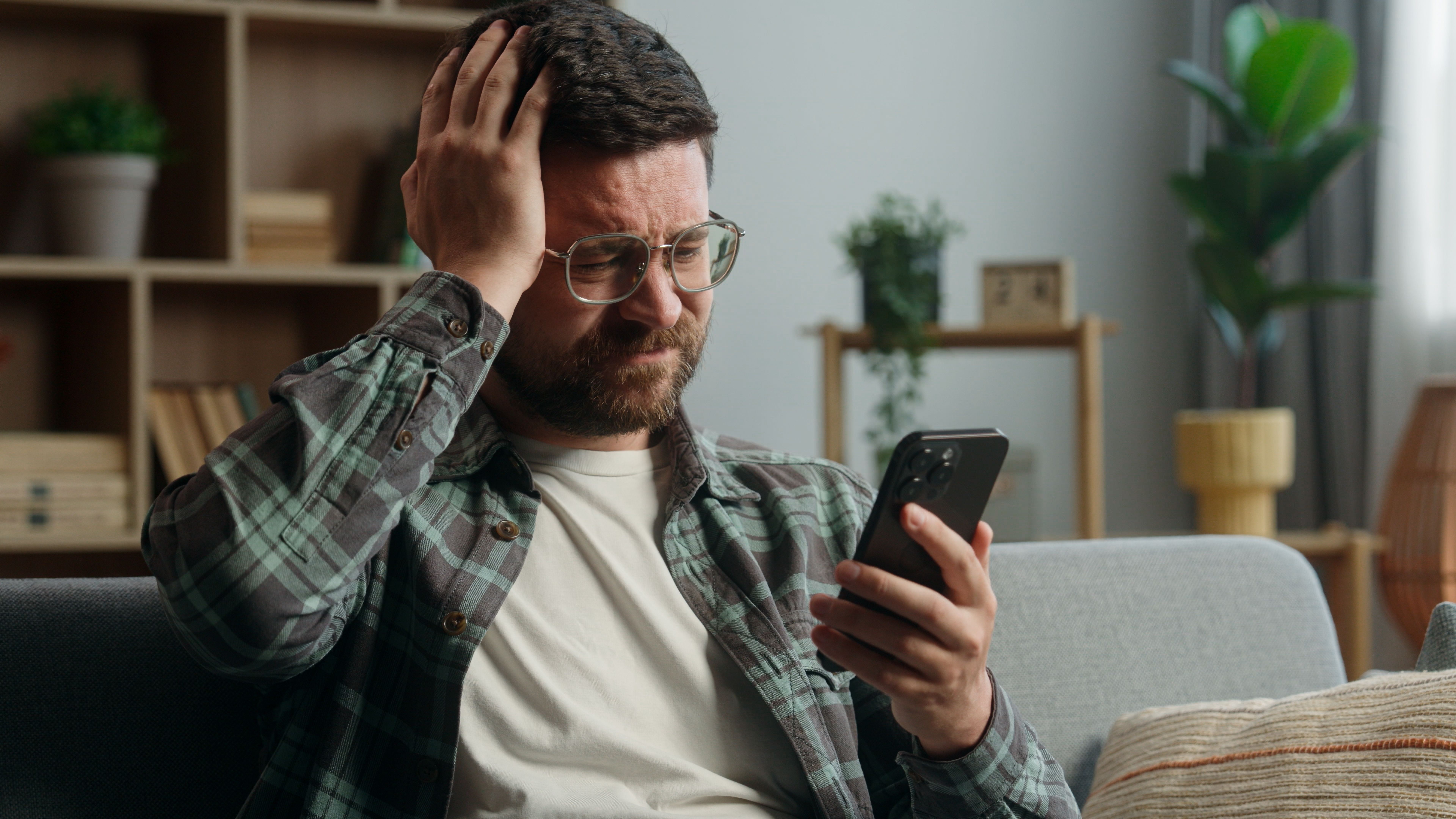 Man looking at his phone concerned