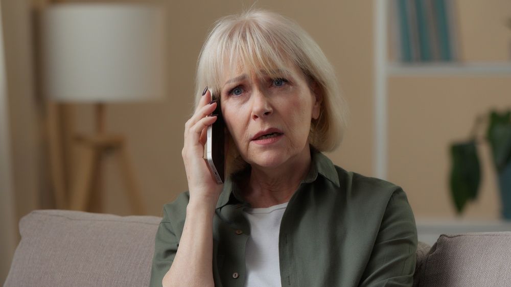 Woman sitting down holding a phone