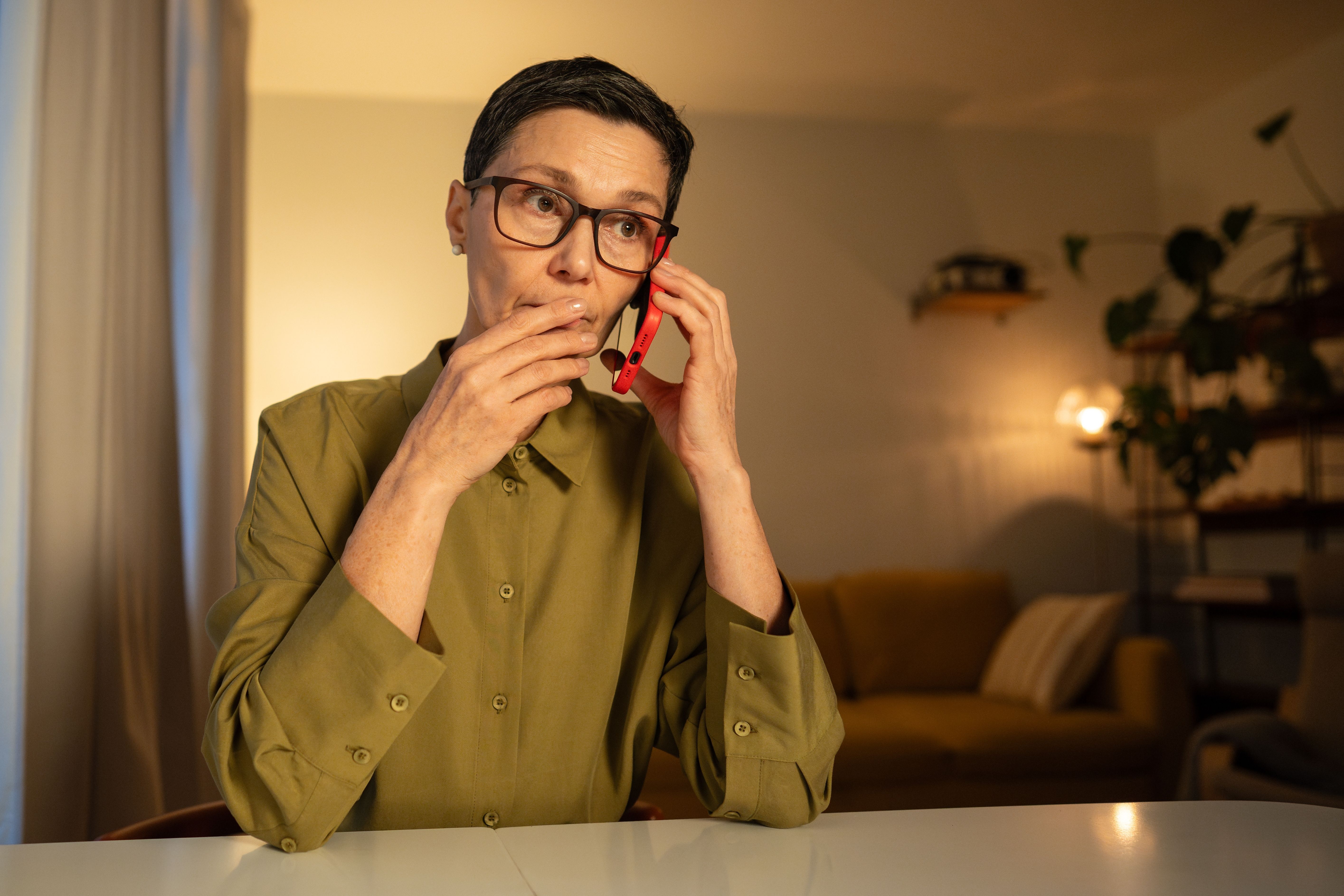 Woman looking concerned on the phone.